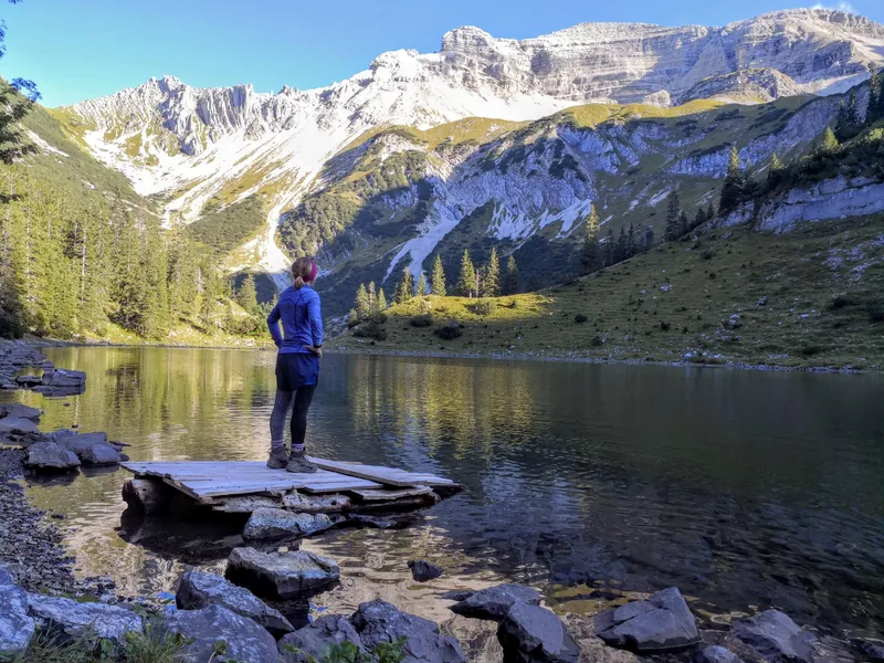 A calm mountain lake surrounded by peaks